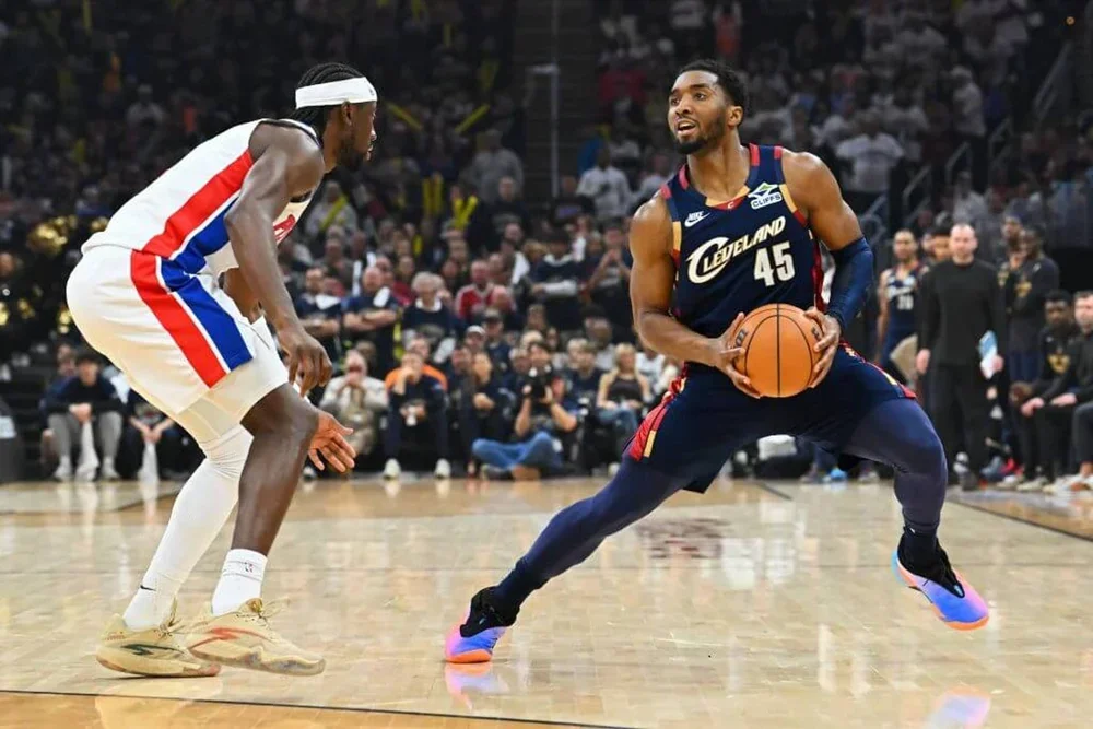 Donovan Mitchell takes a step back to shoot a 3 over Caris LeVert.